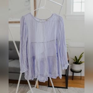 Periwinkle long sleeved babydoll top with open back.